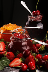 assortment of jams, seasonal berries, apricot, mint and fruits. marmalade or confiture