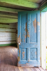 Blue Door in Log Cabin with Distressed Paint