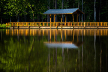 Reflection of a pedestrian bridge over water.  