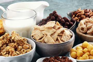 Cereal. Bowls of various cereals and milk for breakfast. Muesli with kids cereals.