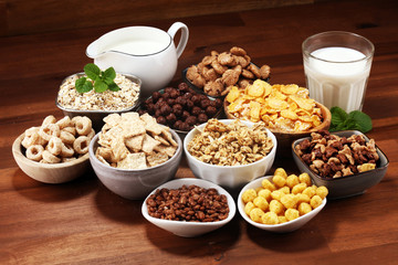 Cereal. Bowls of various cereals and milk for breakfast. Muesli with kids cereals.