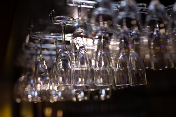 A lot of clean glasses hanging in a bar