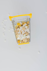 small shopping cart on white background with pills