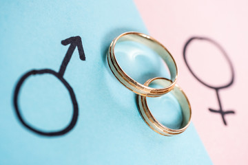 Gender symbols Venus and Mars indicate man and woman with wedding rings. Heterosexual marriage.