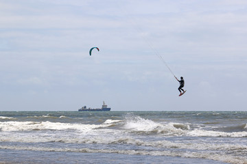 Kitesurfer jumping in waves