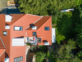 Aerial view of couple having breakfast on roof terrace. Fun concept for people living in the city.