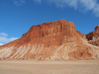 Red high cliffs at Praia da Falesia, a paradise beach in Albufeira in Portugal