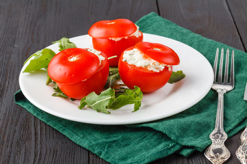 tomatoes stuffed with spinach, cheese and herbs, close up. Delicious and nutritious vegetarian meal