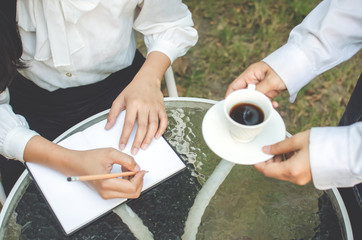 business woman in white shirt working in cafe