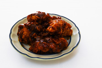 isolated plate of chicken wings with bbq sauce