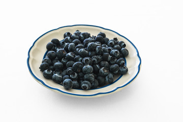 blueberries in a bowl isolated on white background