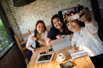 group of business woman taking selfie in cafe