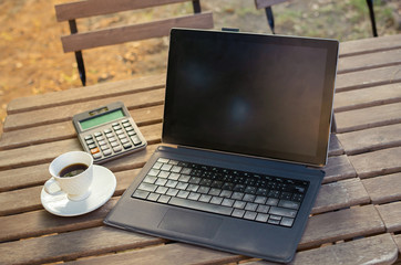 blank laptop with coffee on wooden table