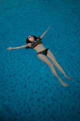 UAE. Woman, swimming pool, relax