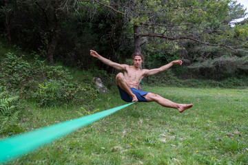 Fototapeta na wymiar Athletic male exercises on balance beam