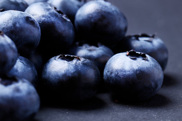 Blueberries closeup on a black background. Top view