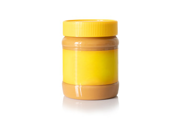 Jar of creamy peanut butter with yellow cap and yellow label isolated on white background. Mock up