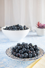 Fresh picked blueberries in a light and bright kitchen environment.