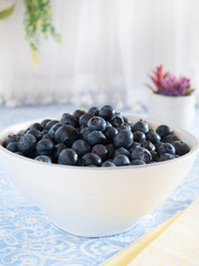 Fresh picked blueberries in a light and bright kitchen environment.