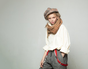old fashioned child in beret. retro fashion model. Vintage suspender. street kid with dirty face. vintage english style. teen girl in retro male suit. copy space. Homelss. modern fashion blog