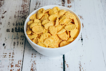 Crispy corn flakes in a bowl on the table