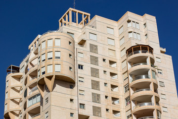 common high living building apartment foreshortening from below on blue sky background 
