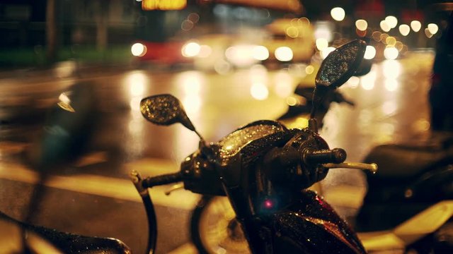 Barcelona city night. Steering wheel closeup. Mirror reflects light and colour. Cars and bikes moving on the background. European holidays. Nightlife in Barna. Shadows and background colour textures