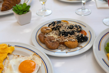 Figs, prunes and sunflower seeds and others on plate - healthy breakfast concept