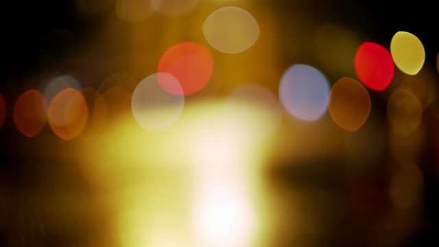 Bokeh light and map of Barcelona in the night. Wet streets and reflections in the pavement. Yellow, red and white light. Eixample grid closeup. Night in the city. Urban plan.