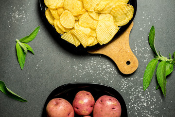 chips and organic potatoes on gray table