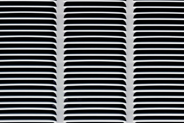 Metal grille for gray ventilation. Industrial background. Black horizontal and diagonal stripes on a gray background.