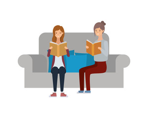 women sitting on chair with book in hands