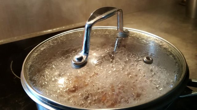 Touching lid of pot that is too hot and letting go and flinching away