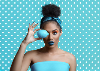Beautiful attractive young woman with creative make-up and lemon near the eye