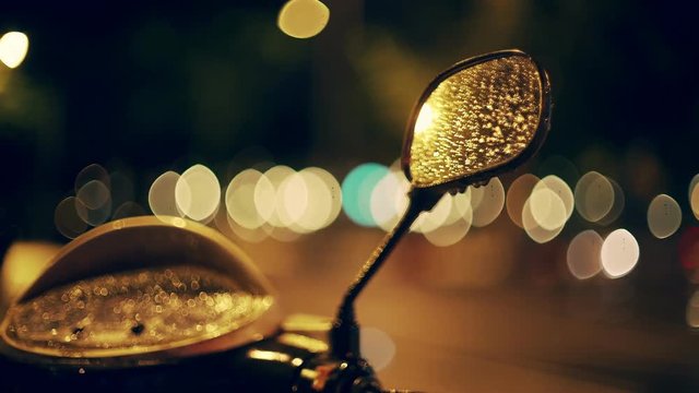 Barcelona city night. Steering wheel closeup. Mirror reflects light and colour. Cars and bikes moving on the background. European holidays. Nightlife in Barna. Shadows and background colour textures