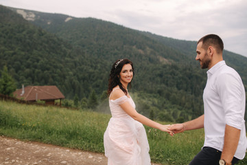 Fototapeta na wymiar Beautiful wedding couple in Carpathian mountains. Handsome man with attractive woman