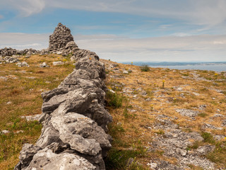 Dry stone fence. Burren National Park, Blue cloudy sky. Rural Ireland.