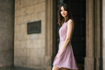 beautiful young girl in dress is resting outdoors, woman is walking on the street