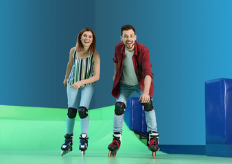 Happy couple having fun at roller skating rink