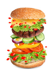 Delicious burger with different flying ingredients on white background