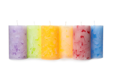 Six color wax candles on white background