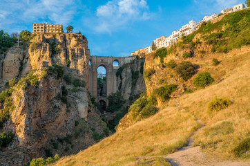 Obraz premium Ronda and its historic bridge in the late afternoon sun. Province of Malaga, Andalusia, Spain.
