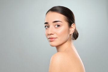 Portrait of young woman with beautiful face against color background