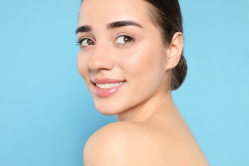 Fototapeta premium Portrait of young woman with beautiful face against color background
