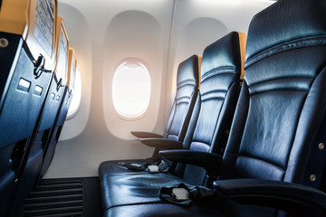 Plane interior - cabin with modern leather chair for passenger of airplane. Aircraft seats and...