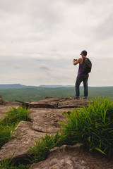 Obraz premium Man hiker on a top of a mountain