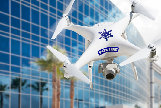 Police Unmanned Aircraft System, (UAS) Drone Flying Near City Highrise Building
