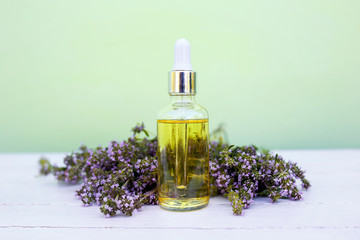 Obraz na płótnie Canvas bottle of essential oil with flowers