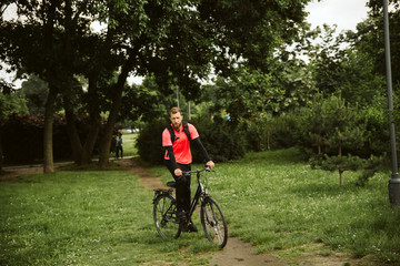  Handsome man and his bicycle in nature. Healthy life