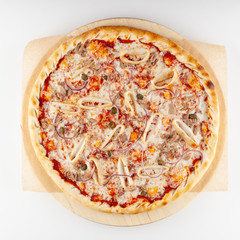 Round seafood pizza on thick dough with squids, red onion, tuna, capers and big amount of mozzarella, isolated on white background